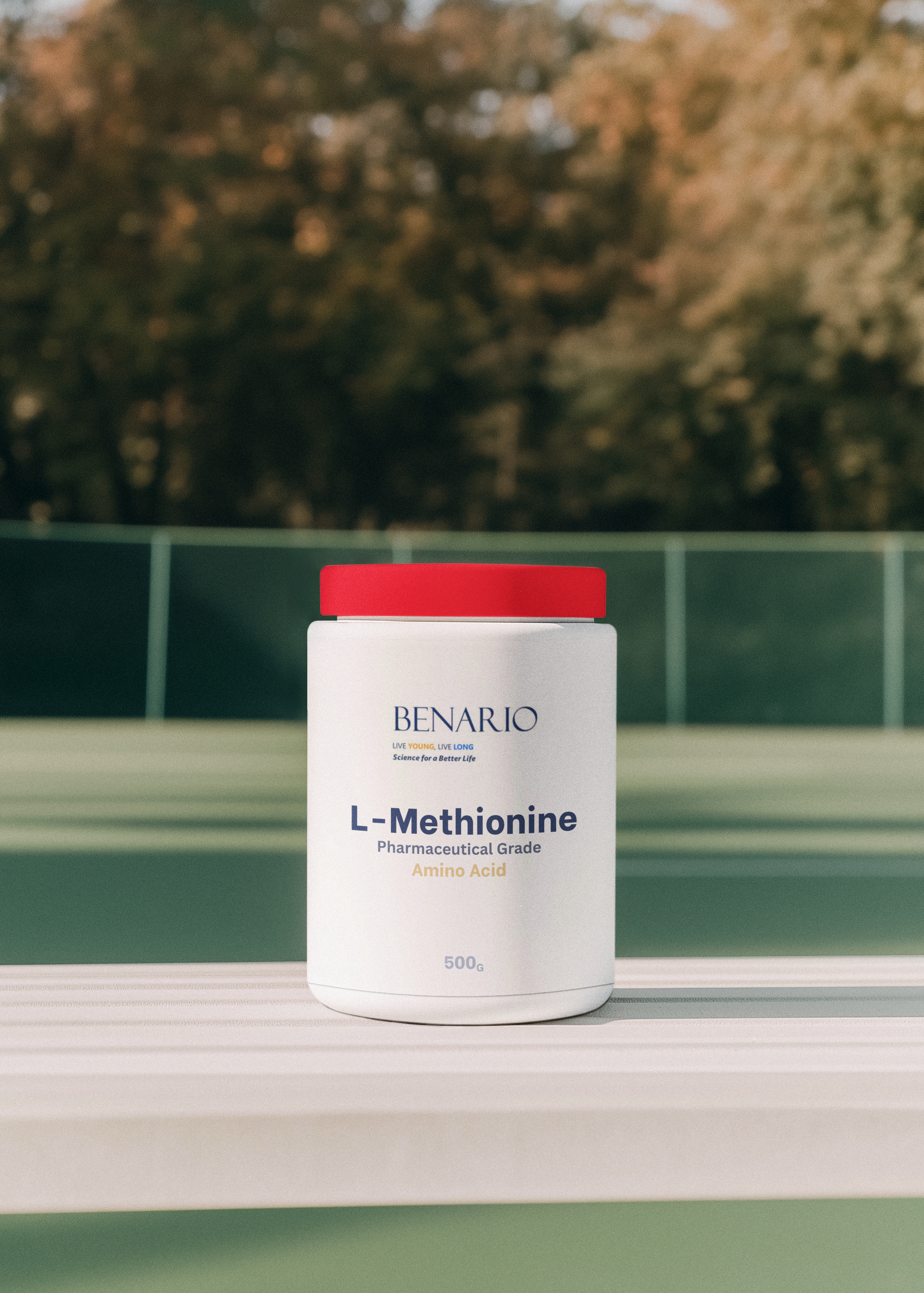 Container of Benario L-Methionine supplement on a surface with a blurred natural background
